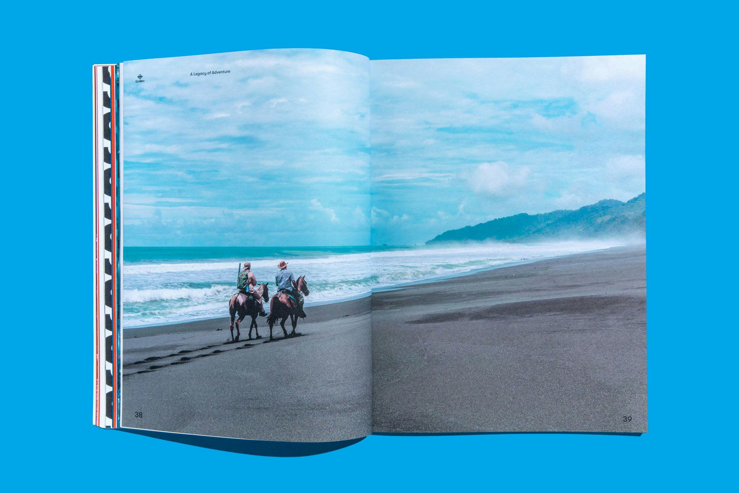 A two-page spread showing to individuals horseback riding on a beach