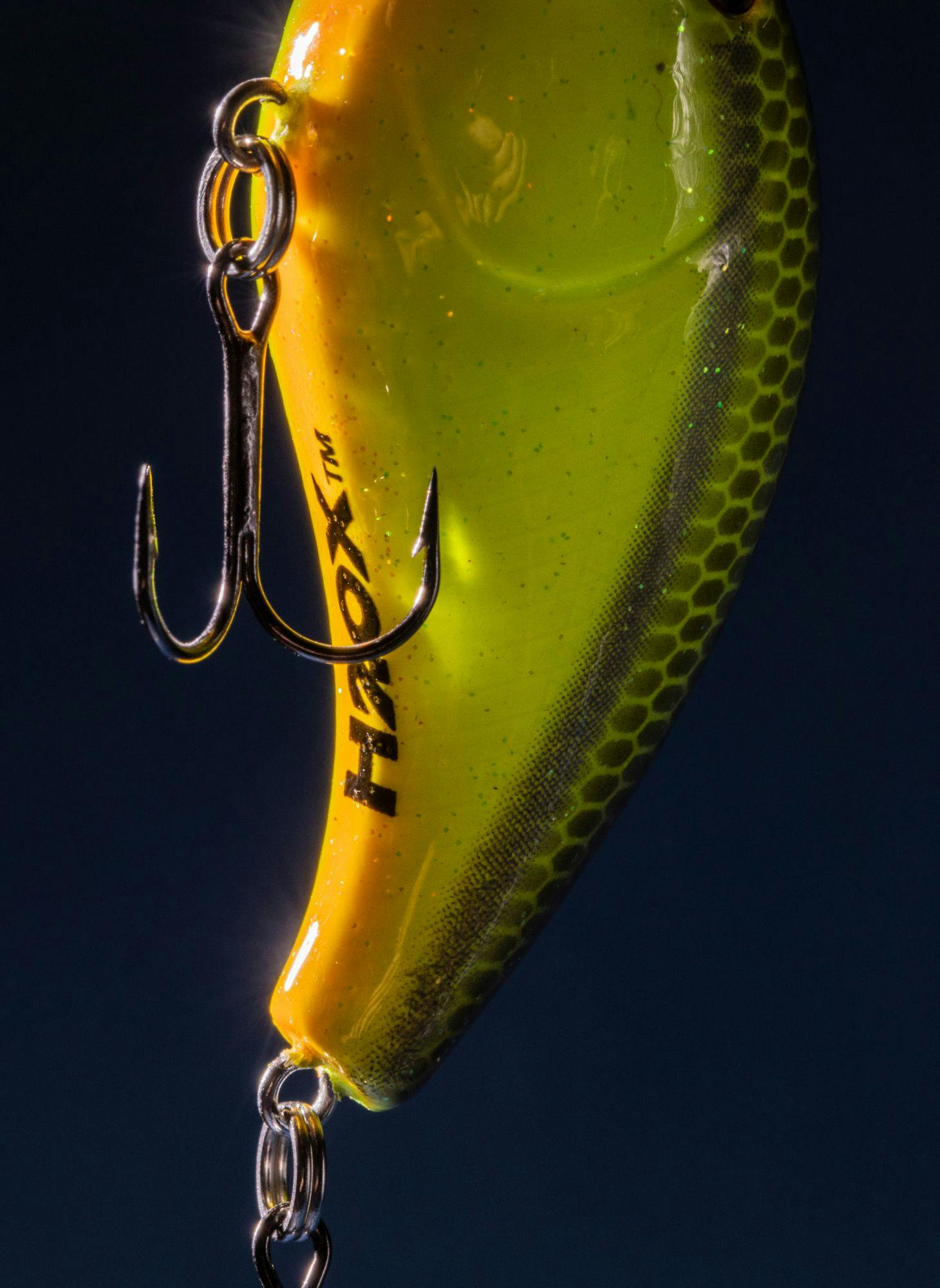 A bright yellow fishing lure and hook