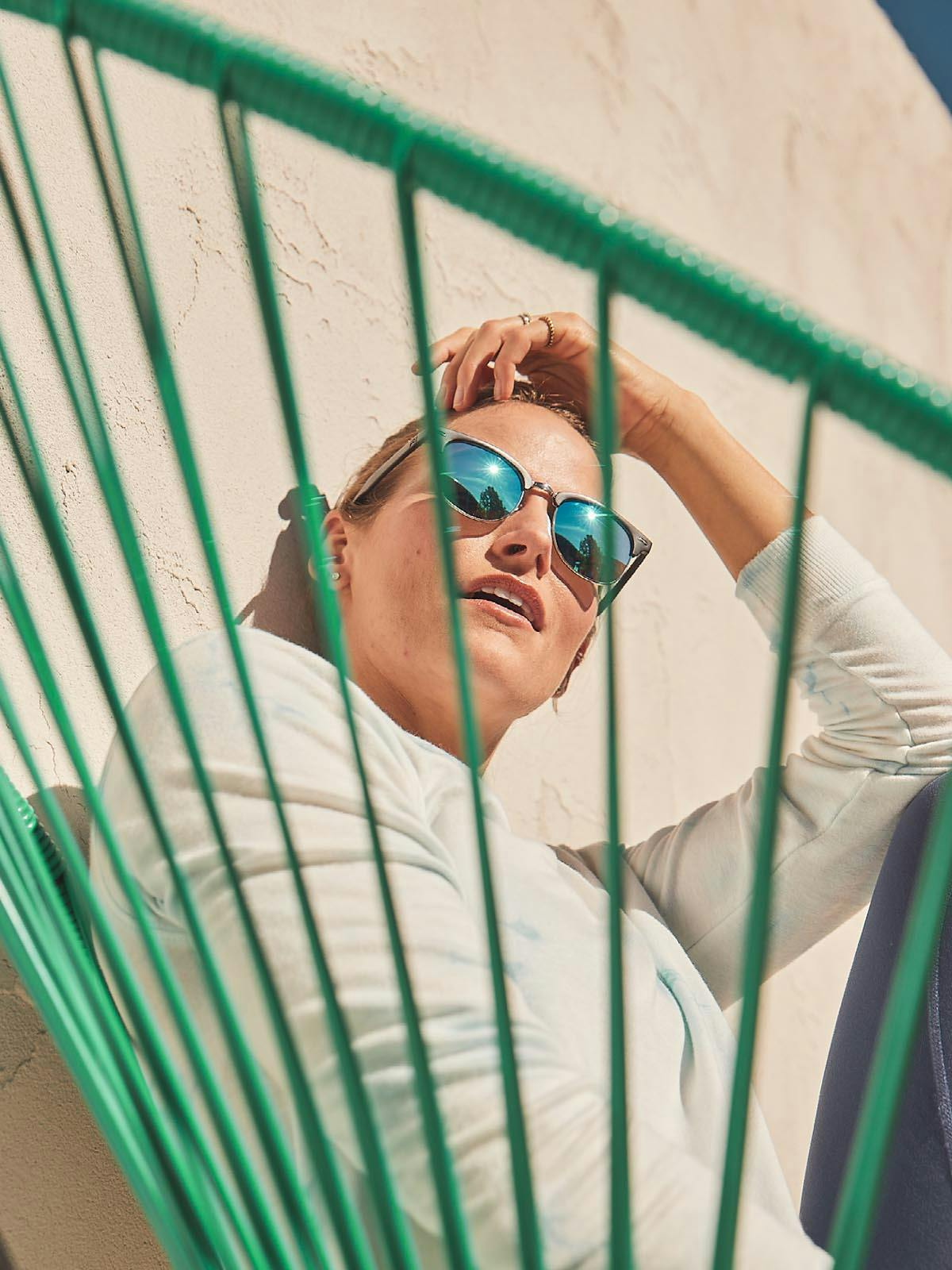 Woman Sitting Outside Wearing Sunglasses