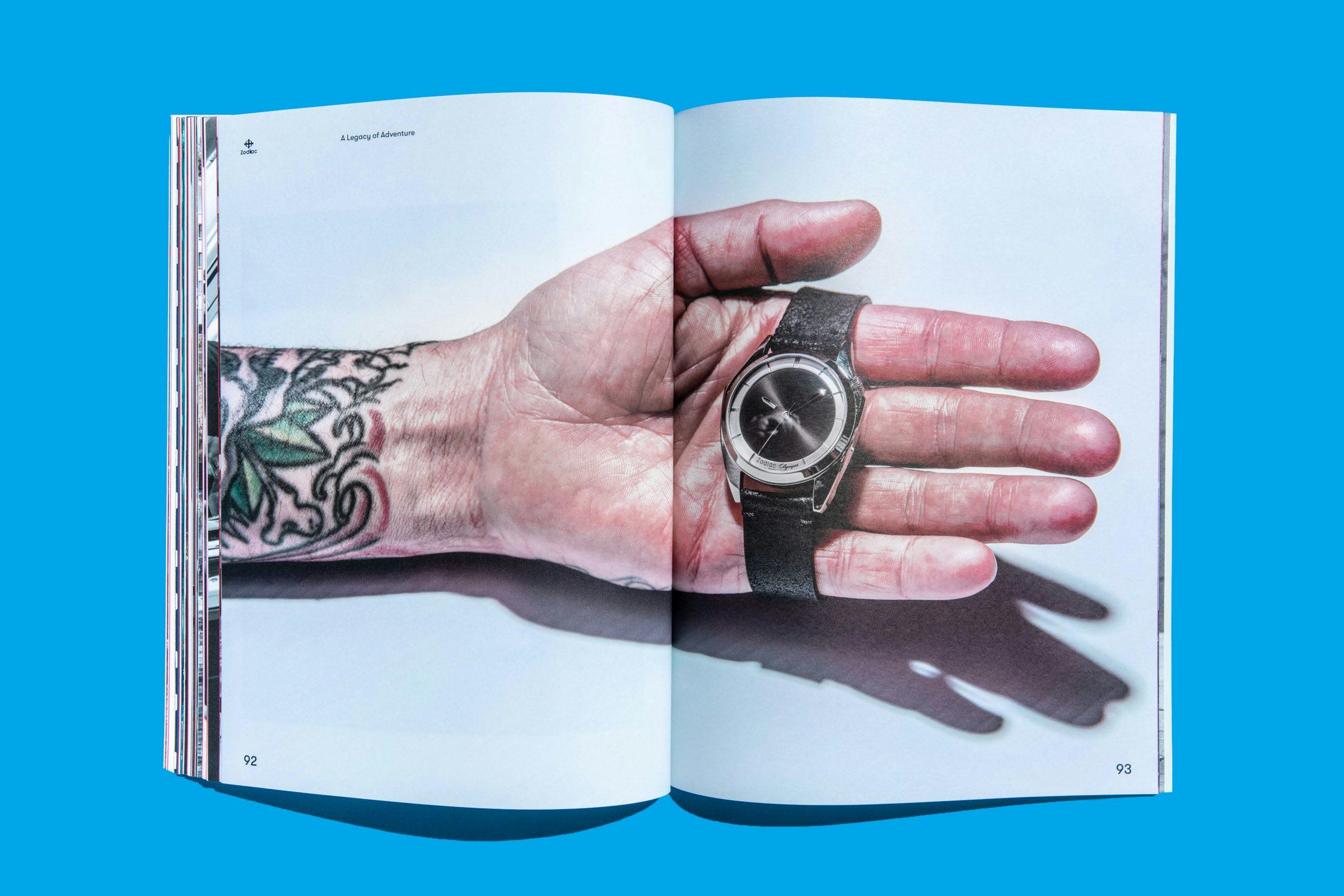 A two-page spread showcasing someone holding a luxury Zodiac watch