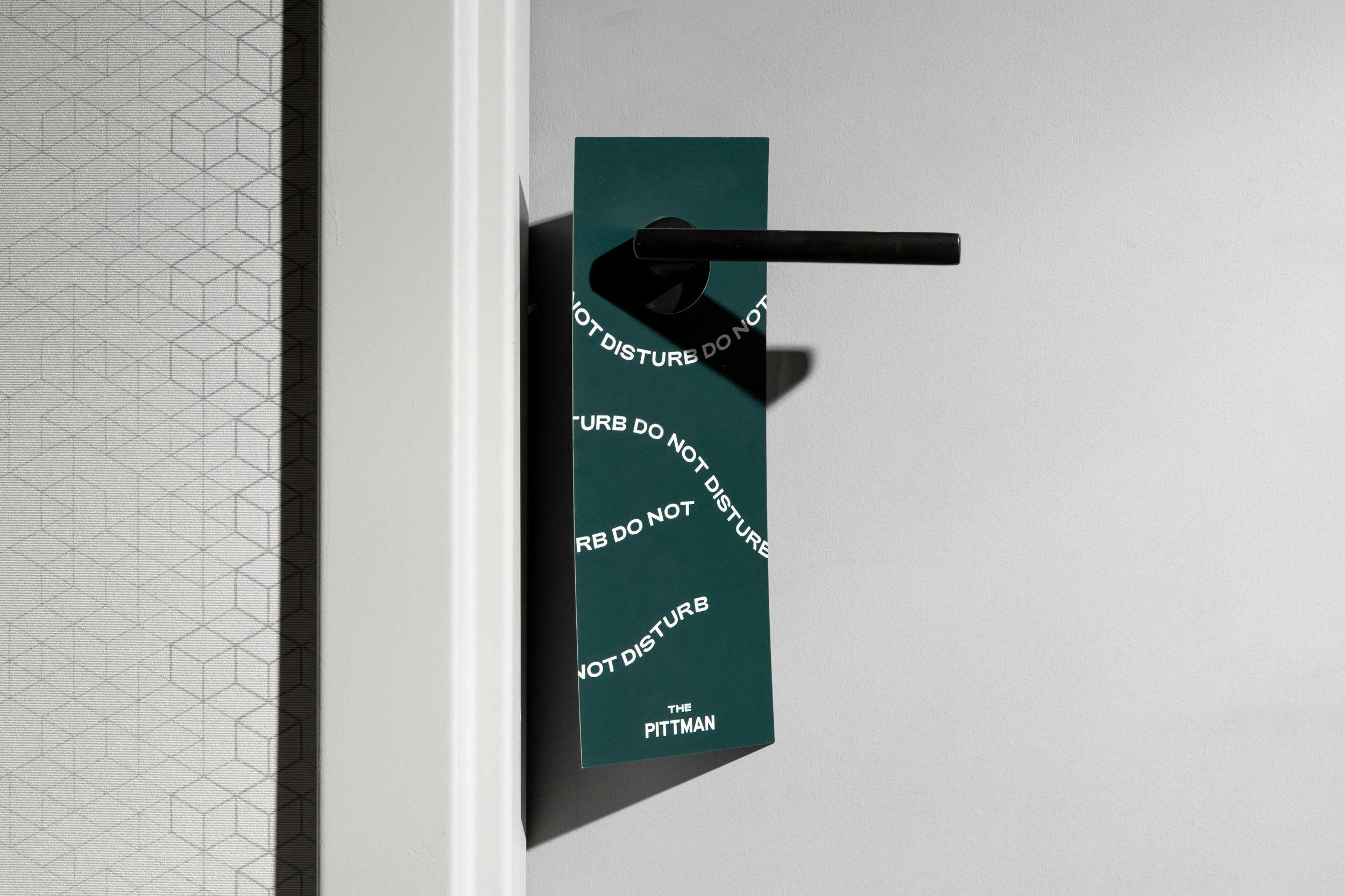 Do not disturb sign on the door-handle of a Pittman Hotel room