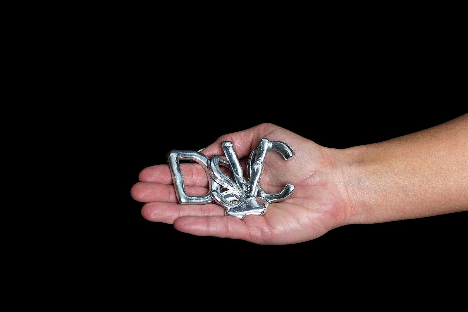 Hand holding a melting foil DSVC logo