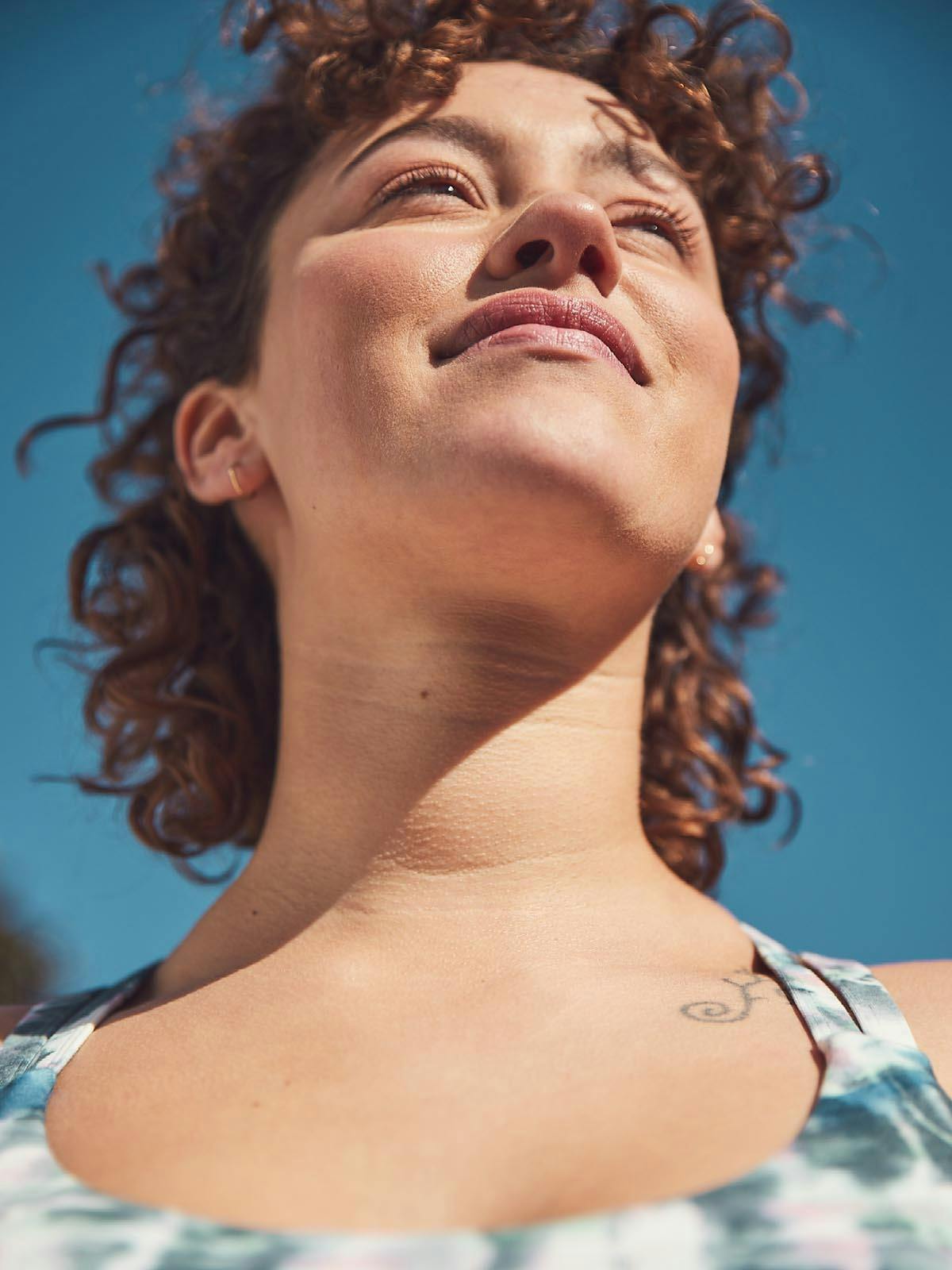 Curly-Haired Woman Smiling